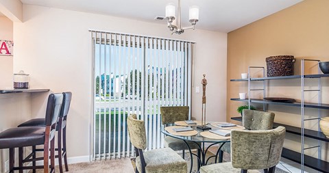 a dining room with a table and chairs and a window