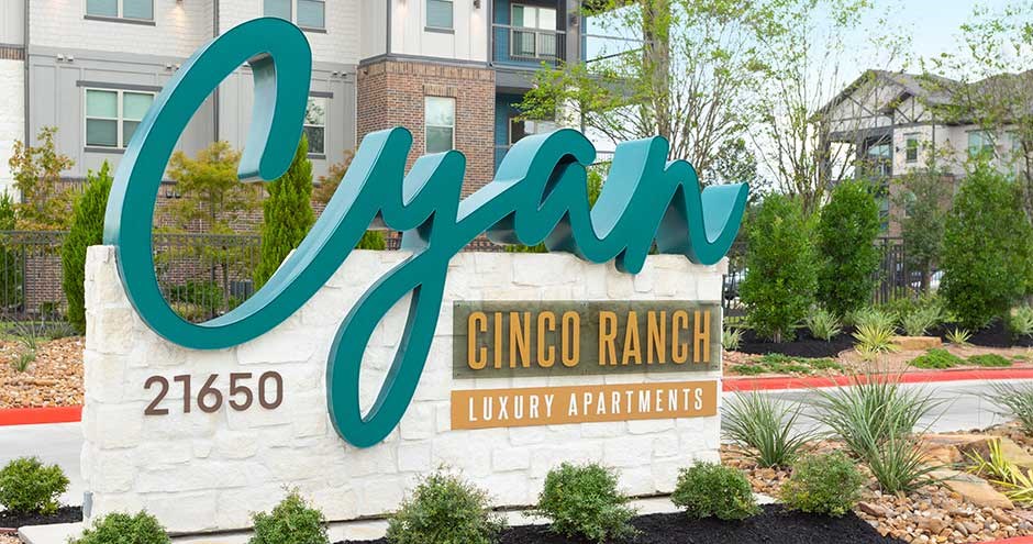 a sign in front of an apartment building