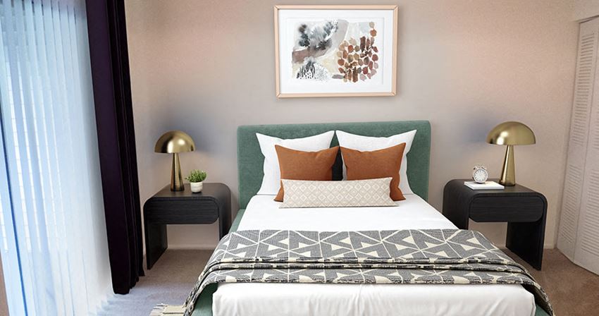 a bedroom with a bed with pillows and a green headboard and a picture