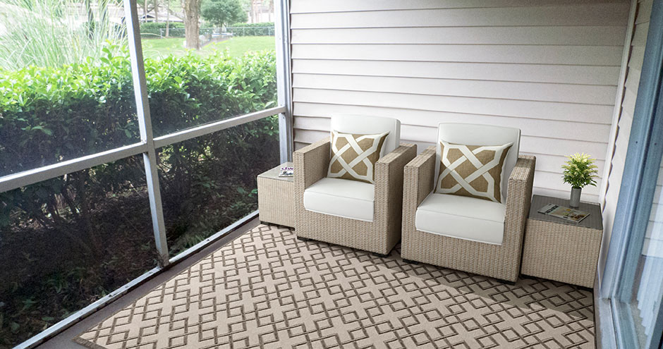 a porch with two chairs and a window