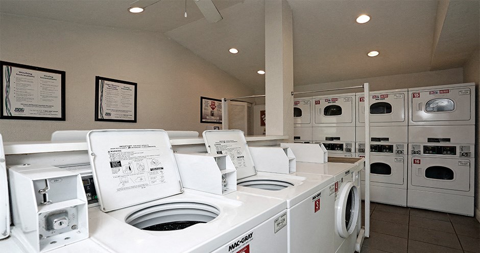 a laundry room filled with lots of washers and dryers
