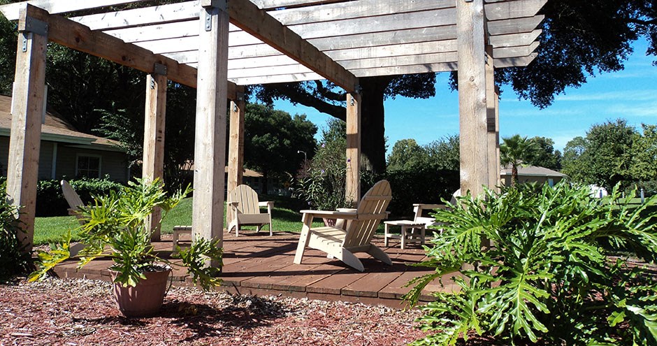 a patio with chairs and a pergola