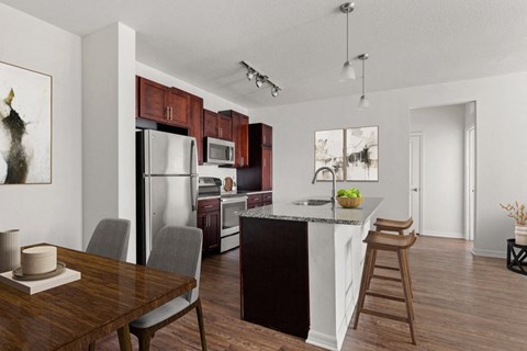 a kitchen and dining room with a table and chairs and a refrigerator