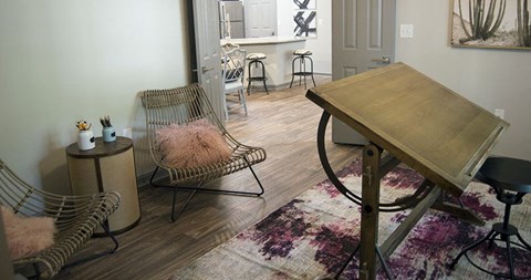 a living room with a table and a chair