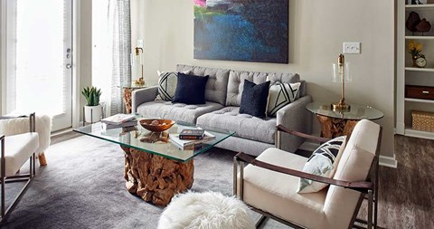 a living room with a couch and a glass table
