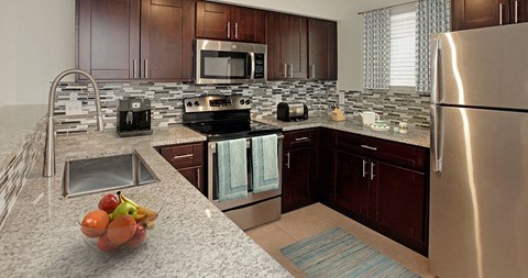 a kitchen with stainless steel appliances and granite counter tops