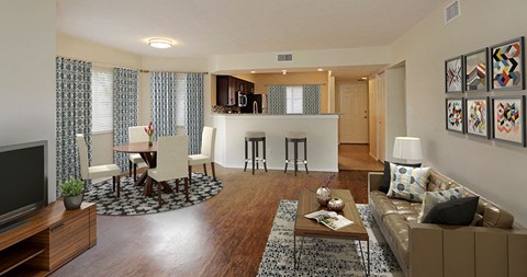 a living room and kitchen with a couch and a table