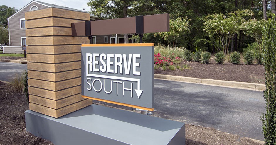 a sign that says reserve south in front of a driveway