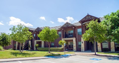 an apartment building with trees in front of it