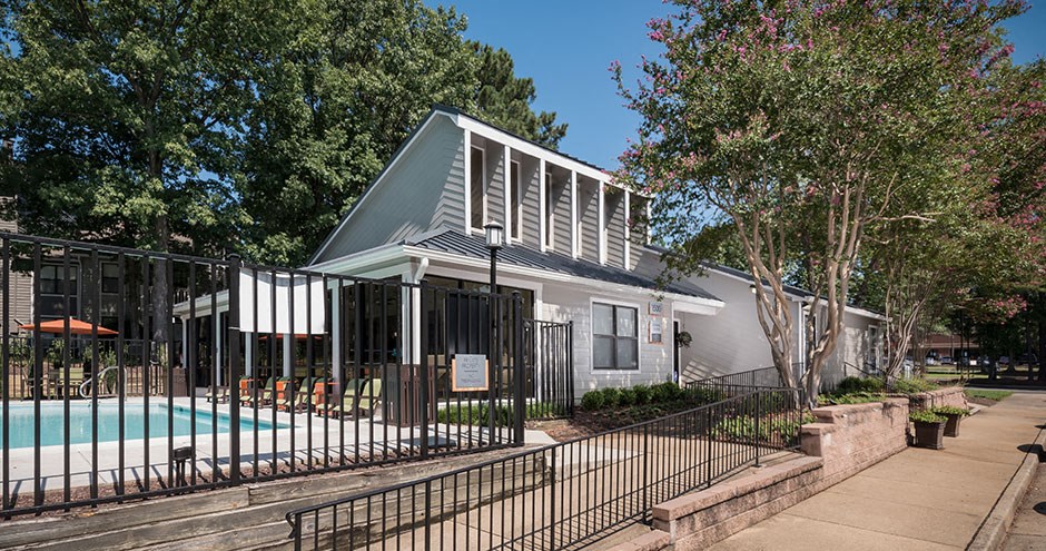 a house with a pool and a wrought iron fence