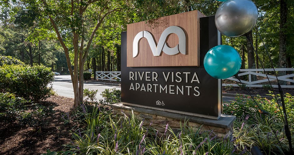 a sign at the entrance of river vista apartments