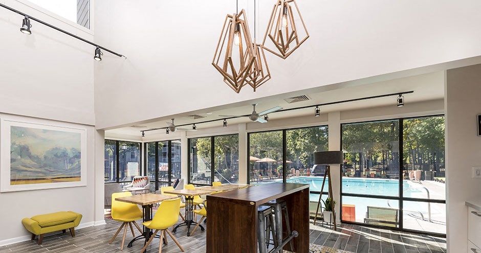 a living room with a pool and a table and chairs