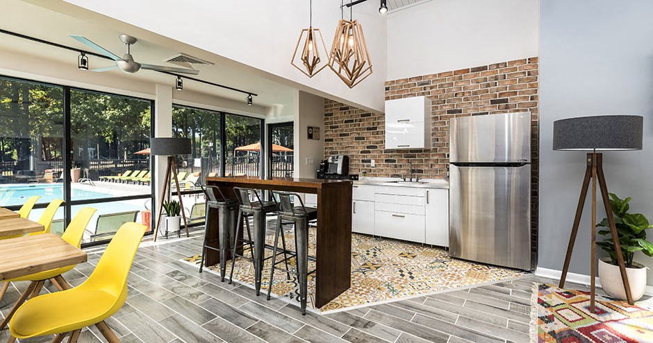 a kitchen with a bar next to a pool