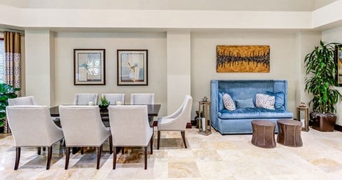 a living and dining room with a blue couch and a table and chairs