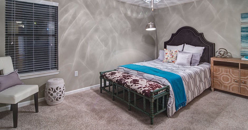 a bedroom with a bed and a dresser and a window