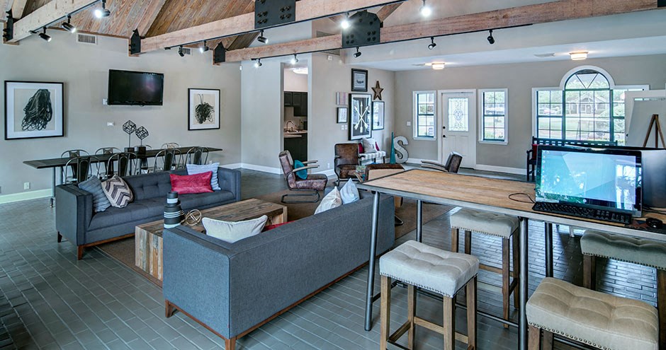 a living room with a couch and a bar and a television