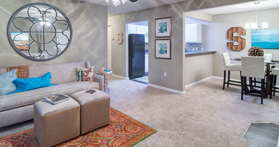 a living room with a couch and a dining room table
