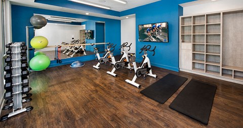 a gym with exercise equipment and yoga mats