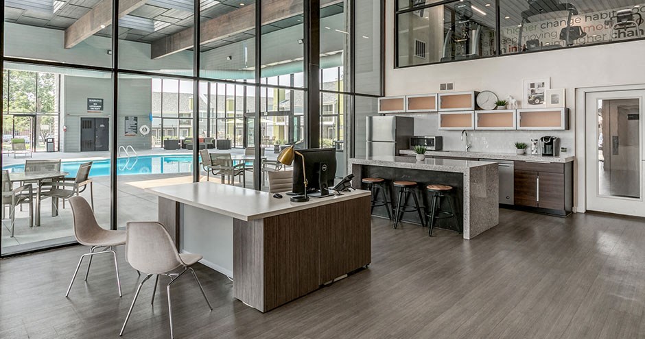 a large office with a desk and chairs and a pool