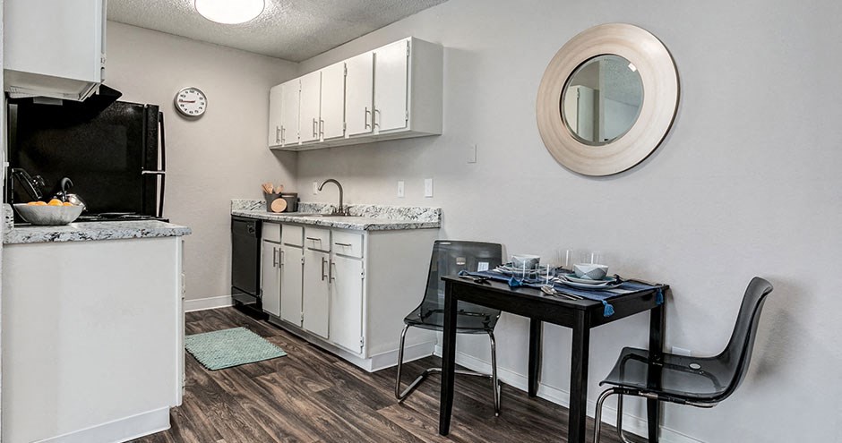 a kitchen with a table and chairs and a counter top