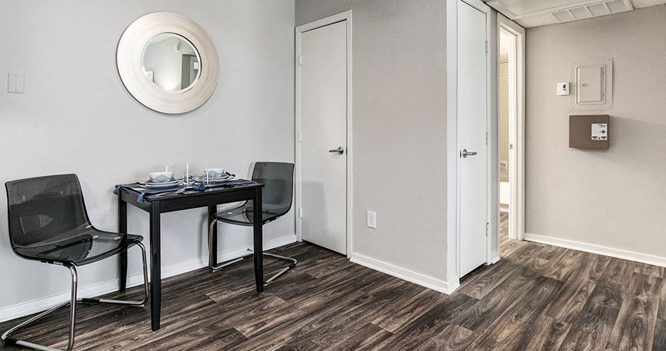 a room with two chairs and a table and a mirror