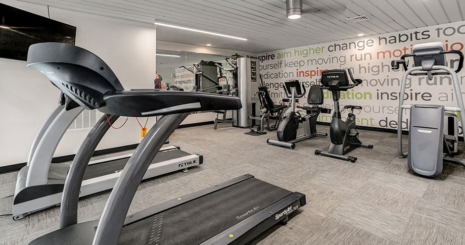 a gym with treadmills and other exercise equipment in a building