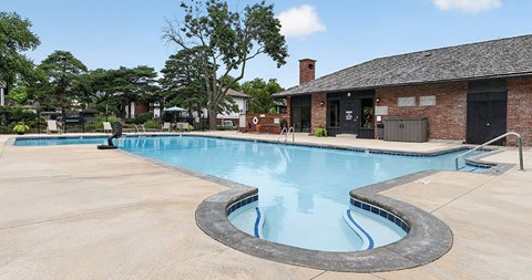 A swimming pool with a small waterfall in the middle.