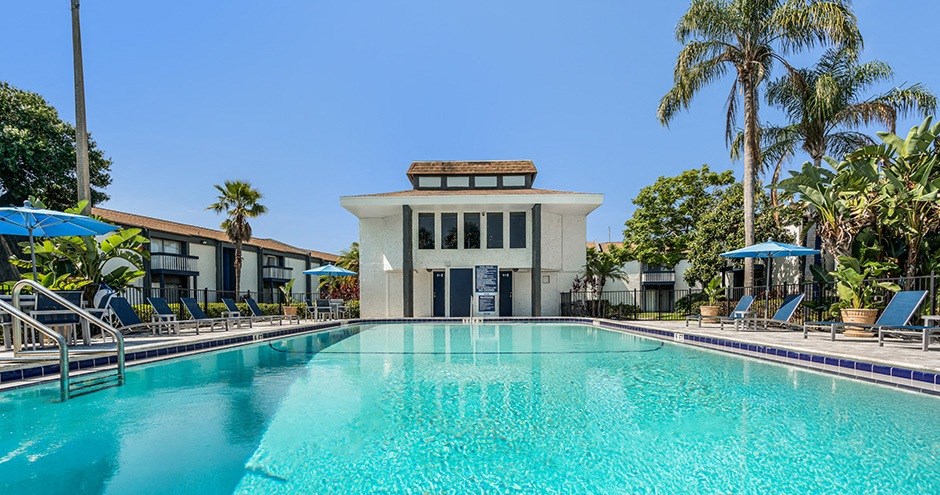 a swimming pool with a building in the background