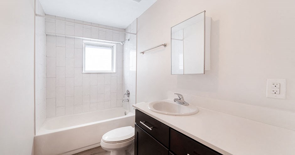 a bathroom with a sink and a toilet and a shower