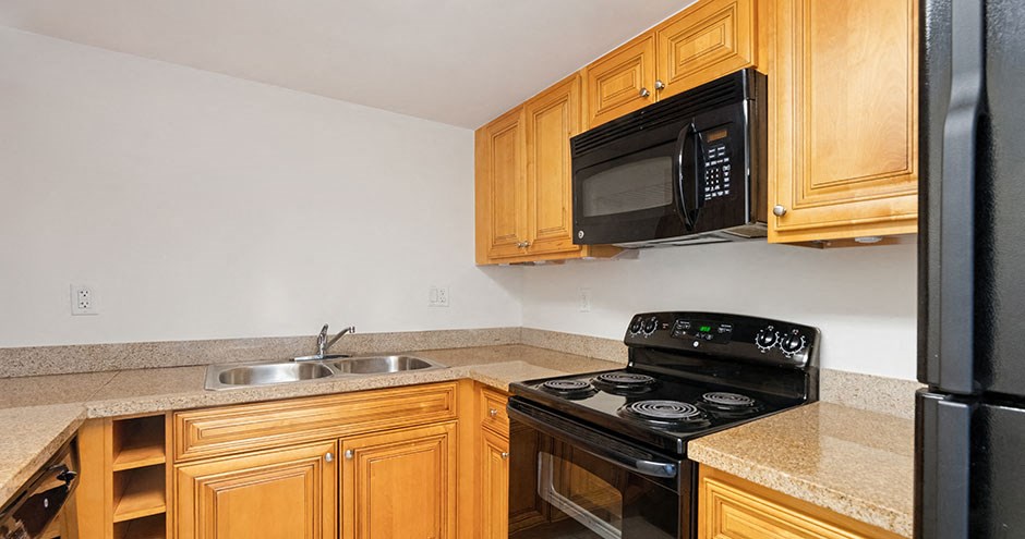 a kitchen with a stove microwave and sink