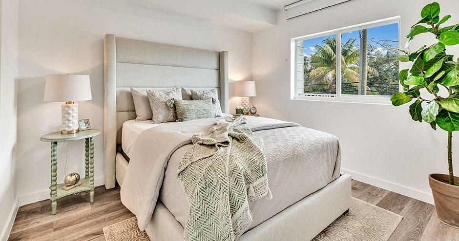 a bedroom with a bed and a window