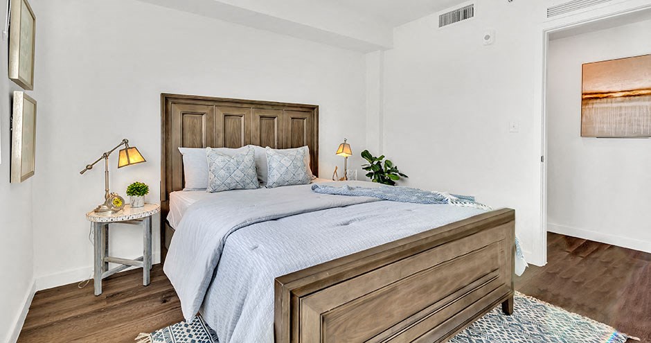 a bedroom with a bed and a wooden headboard