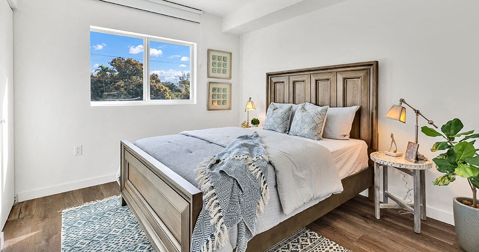 a bedroom with a bed and a window