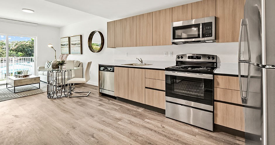 a kitchen with stainless steel appliances and wooden cabinets