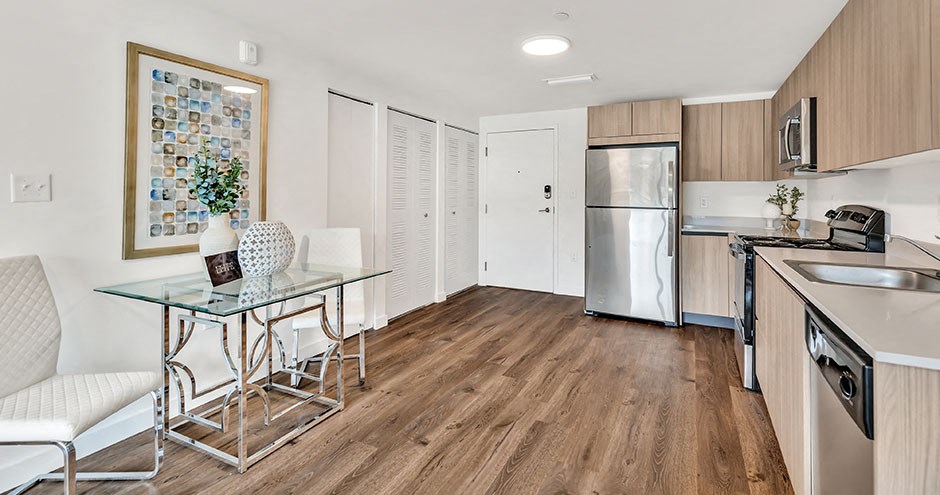 a kitchen and dining room with a glass table