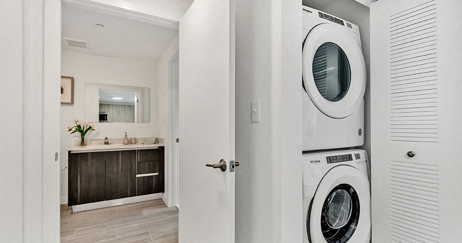 a white laundry room with a washer and dryer