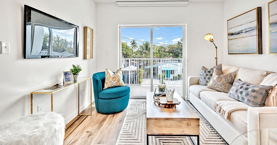 a living room with a sliding glass door to a balcony