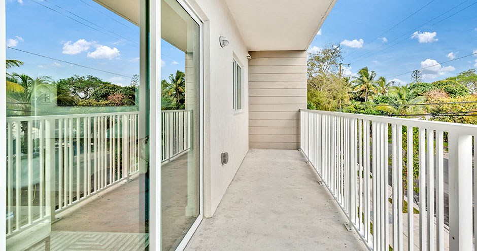 the spacious balcony has views of the pool and the trees