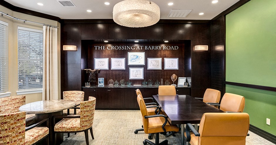 a conference room with a table and chairs and a sign on the wall