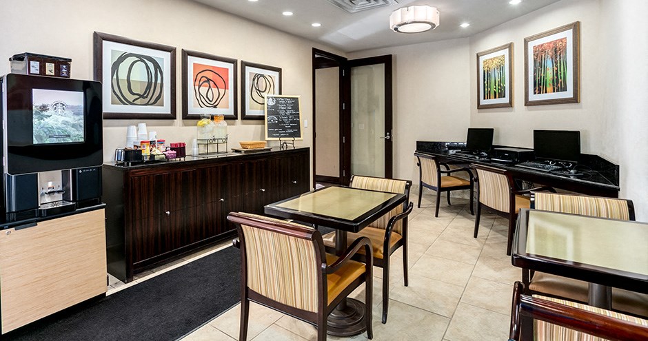a dining area with tables and chairs and a television