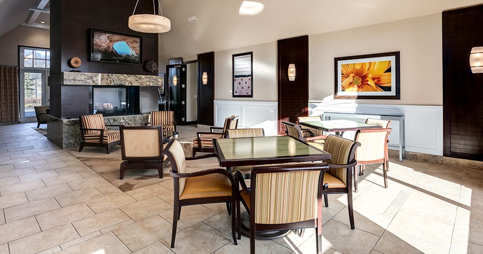 a dining room with tables and chairs and a fireplace