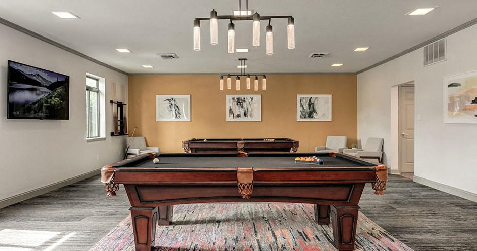a game room with a pool table