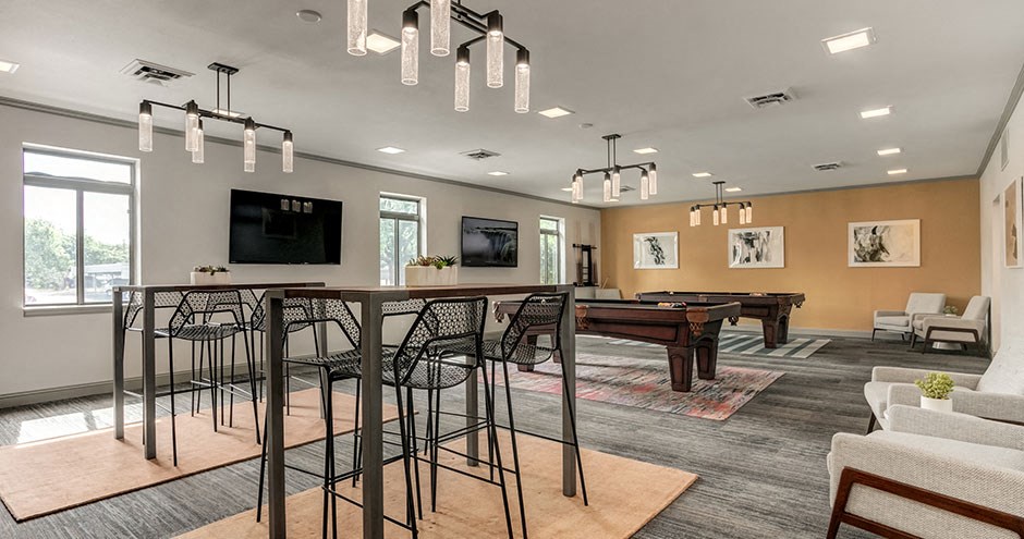 a living room with a bar and a pool table