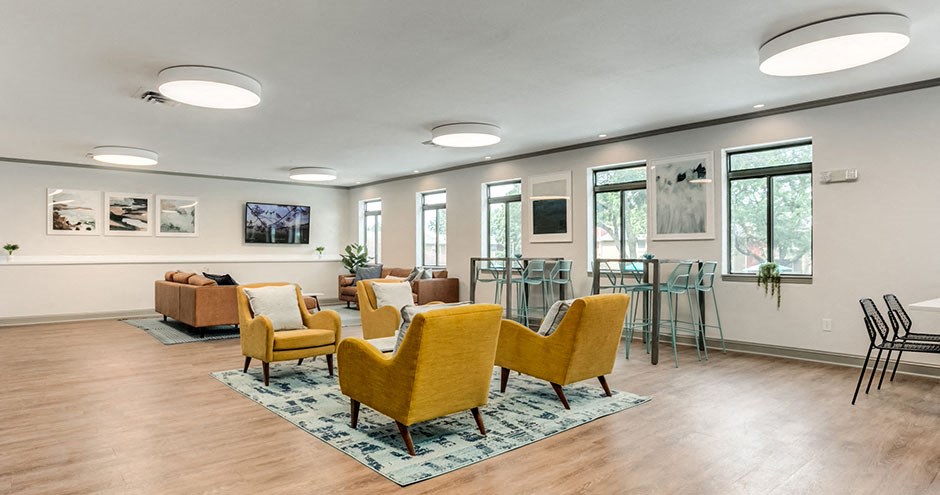a living room with a couch and chairs and a table