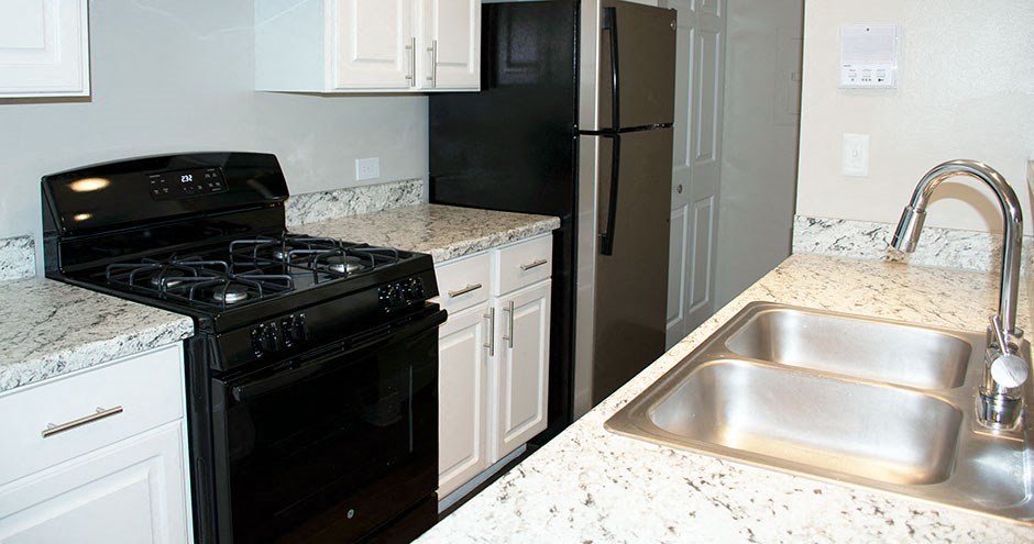 a kitchen with a stove sink and refrigerator