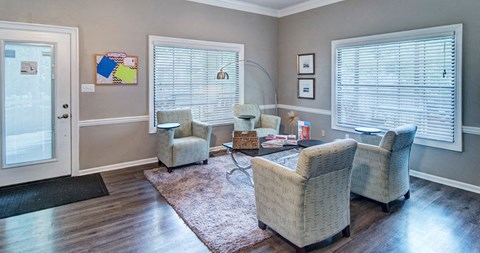 a living room with two chairs and a table