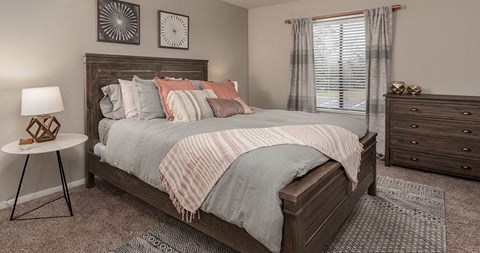a bedroom with a bed and a window