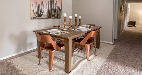 a dining room with a table and chairs