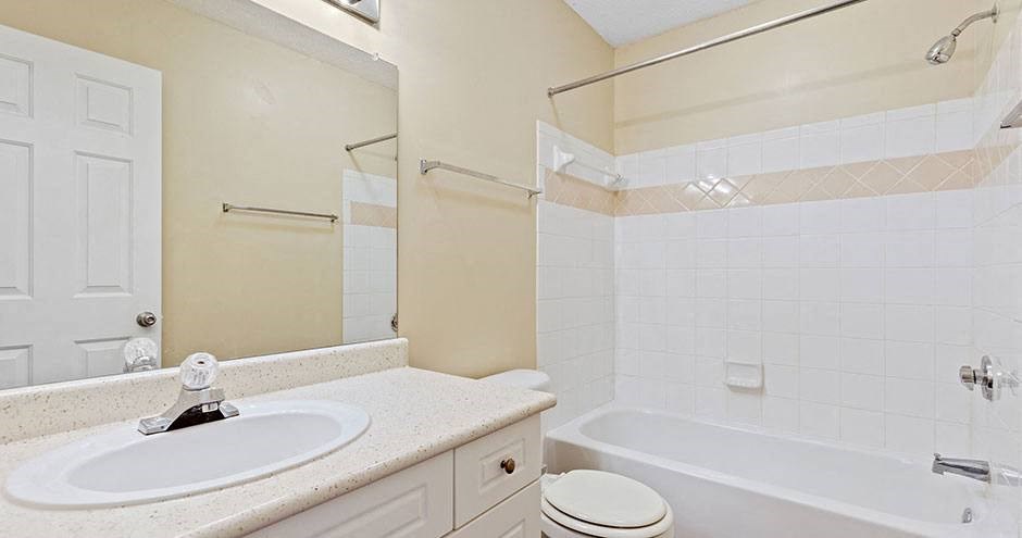 a bathroom with a sink toilet and a bath tub