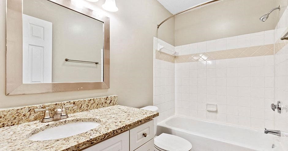 a bathroom with a sink toilet and a bath tub